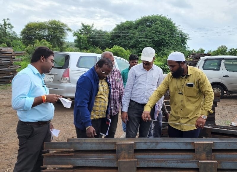 Engineering team reviewing bridge drawings on site